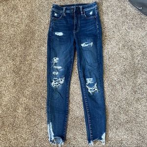 skinny, high waisted, dark blue jeans with various holes!